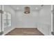 Office showcasing hardwood floors, window, modern chandelier, and built-in storage at 3176 Pearly Dr, Lakeland, FL 33812
