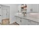 Well-organized pantry with white cabinets, open wooden shelving, and stylish decor at 3176 Pearly Dr, Lakeland, FL 33812