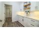 Pantry with marble countertops, white cabinets, and wood-look floors at 3176 Pearly Dr, Lakeland, FL 33812
