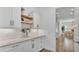 Charming pantry with marble counters, white cabinets, subway tile, and decorative shelves at 3176 Pearly Dr, Lakeland, FL 33812