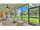 Screened in porch with brick floor and comfortable seating overlooking green space at 3176 Pearly Dr, Lakeland, FL 33812