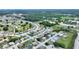 Aerial view of a residential area with a home marked with a red pin, surrounded by a golf course at 3618 Highland Fairways Blvd, Lakeland, FL 33810