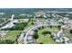 Aerial view of a neighborhood with a home marked with a red pin, surrounded by lush greenery at 3618 Highland Fairways Blvd, Lakeland, FL 33810