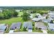 An aerial shot of a property with a gray roof surrounded by green lawns and neighborhood homes at 3618 Highland Fairways Blvd, Lakeland, FL 33810
