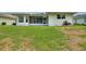 The expansive backyard features lush green grass leading up to the home's screened-in porch at 3618 Highland Fairways Blvd, Lakeland, FL 33810