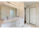 Bathroom with double sinks, large mirror, white cabinetry and tiled floor at 3618 Highland Fairways Blvd, Lakeland, FL 33810