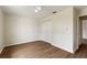 Bedroom featuring wood-look floors, white walls and closet at 3618 Highland Fairways Blvd, Lakeland, FL 33810