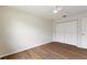 This bedroom features clean white walls, a ceiling fan, and modern laminate flooring for a fresh look at 3618 Highland Fairways Blvd, Lakeland, FL 33810