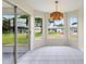 Bright dining room features tile floors, large windows, and modern light fixture at 3618 Highland Fairways Blvd, Lakeland, FL 33810