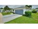 A single-story home featuring well-kept landscaping, a driveway, and a blue two-car garage at 3618 Highland Fairways Blvd, Lakeland, FL 33810