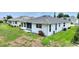 Home exterior with lush yard, landscaping and cozy screened-in porch at 3618 Highland Fairways Blvd, Lakeland, FL 33810