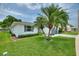 A single-story home surrounded by lush green grass and palm trees, with a well-kept lawn at 3618 Highland Fairways Blvd, Lakeland, FL 33810