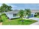 A single-story home surrounded by lush green grass and palm trees, with a well-kept lawn at 3618 Highland Fairways Blvd, Lakeland, FL 33810