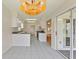 Galley kitchen with white cabinets, neutral counters, and adjacent tiled dining area at 3618 Highland Fairways Blvd, Lakeland, FL 33810