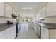Bright kitchen with white cabinetry, stainless steel appliances, and a sunlit breakfast nook at 3618 Highland Fairways Blvd, Lakeland, FL 33810