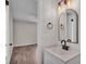 Updated bathroom featuring a stylish vanity with a modern faucet, lighting, and a round top mirror at 3829 Abbott Ln, Lakeland, FL 33810