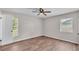 Bedroom featuring wood-look flooring, neutral walls, and plenty of natural light at 3829 Abbott Ln, Lakeland, FL 33810