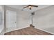 Bedroom featuring wood-look flooring, a ceiling fan, and two white doors for closet and bathroom access at 3829 Abbott Ln, Lakeland, FL 33810