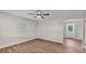Bedroom featuring wood-look flooring, a modern ceiling fan, and a view of the entrance door at 3829 Abbott Ln, Lakeland, FL 33810