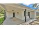 Low shot of the carport of a single story house with neutral paint and black window shutters at 3829 Abbott Ln, Lakeland, FL 33810