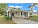 Image features the covered carport, neutral paint and black support beams at 3829 Abbott Ln, Lakeland, FL 33810