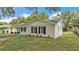 A single-story home with neutral paint, a driveway, a well-maintained lawn, and black window shutters at 3829 Abbott Ln, Lakeland, FL 33810