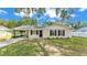 Charming single-story home featuring a well-maintained lawn, neutral paint, and a covered carport at 3829 Abbott Ln, Lakeland, FL 33810