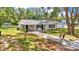 Single-story home featuring a lengthy driveway, neutral paint, and a covered carport at 3829 Abbott Ln, Lakeland, FL 33810