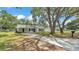 Charming single-story home boasting a lengthy driveway, neutral paint, and a covered carport at 3829 Abbott Ln, Lakeland, FL 33810