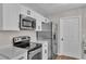 Close-up of updated kitchen with stainless steel appliances and sleek white cabinets at 3829 Abbott Ln, Lakeland, FL 33810