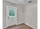 Bright room with wood-look flooring and a door to the backyard at 3829 Abbott Ln, Lakeland, FL 33810
