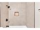 Tiled shower featuring a tiled shampoo niche and black fixtures at 3829 Abbott Ln, Lakeland, FL 33810