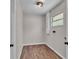 Utility room with wood-look flooring, a water heater, and a window at 3829 Abbott Ln, Lakeland, FL 33810