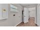Utility room with wood-look flooring, a water heater, a window, and utility connections at 3829 Abbott Ln, Lakeland, FL 33810