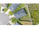 Overhead view of a gray roofed house with a manicured backyard and nearby neighboring homes at 3883 Sandhill Crane Dr, Lakeland, FL 33811