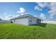 Landscaped backyard with green grass, screen porch, and a vinyl fence offering privacy at 3883 Sandhill Crane Dr, Lakeland, FL 33811