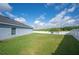 View of the backyard showing the vinyl fence, lawn and home exterior at 3883 Sandhill Crane Dr, Lakeland, FL 33811