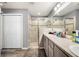 Bathroom features a glass shower, gray cabinets, and double-door storage at 3883 Sandhill Crane Dr, Lakeland, FL 33811