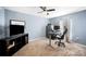 Comfortable bedroom with a ceiling fan, a work-from-home setup, and a nice window view at 3883 Sandhill Crane Dr, Lakeland, FL 33811