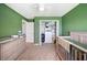 Bedroom with green walls, neutral carpet, closet, and baby furnishings at 3883 Sandhill Crane Dr, Lakeland, FL 33811