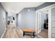 Hallway featuring wood-look floors and access to various rooms with natural lighting at 3883 Sandhill Crane Dr, Lakeland, FL 33811