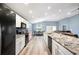 Modern kitchen with stainless steel appliances and adjacent dining area at 3883 Sandhill Crane Dr, Lakeland, FL 33811