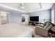 Spacious main bedroom suite featuring a tray ceiling, plush carpet, and serene window lighting at 3883 Sandhill Crane Dr, Lakeland, FL 33811