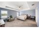 Spacious main bedroom suite featuring a tray ceiling, plush carpet, and serene window lighting at 3883 Sandhill Crane Dr, Lakeland, FL 33811