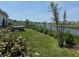 Lush backyard with a fence and view of pond, perfect for outdoor activities and enjoying nature at 3966 Willowbrook Dr, Edgewater, FL 32141