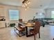 Dining area with a wooden table and bench illuminated by a stylish pendant light fixture at 3966 Willowbrook Dr, Edgewater, FL 32141