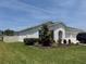 Charming single-story home featuring a well-manicured lawn, white exterior, and a two car garage at 3966 Willowbrook Dr, Edgewater, FL 32141