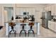 Bright kitchen with stainless steel appliances, center island with bar stool seating, and gray countertops at 3966 Willowbrook Dr, Edgewater, FL 32141