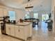 Open-concept kitchen and dining area flowing into a cozy living room with sliding door access to the backyard at 3966 Willowbrook Dr, Edgewater, FL 32141