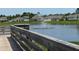 Picturesque community pond view with a fountain and wooden deck area for relaxation at 3966 Willowbrook Dr, Edgewater, FL 32141